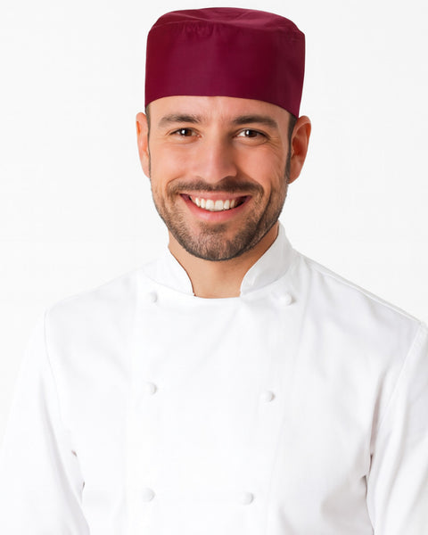 Adjustable chef skull cap in burgundy worn by smiling chef in white uniform, perfect for professional kitchens. custom chef hat, popular chef hats